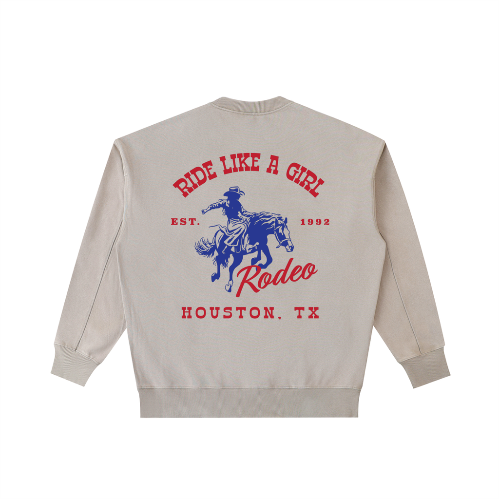 Shop the Houston, TX "Ride Like A Girl" Rodeo Crewneck in Off-White. This cream-colored vintage-washed heavyweight sweatshirt features a red and navy horse-and-rider back graphic. The ultimate clean Coastal Cowgirl staple.