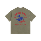 Back view of an Army Green Heavyweight Boxy T-Shirt with a red and blue Houston TX Rodeo "Ride Like A Girl" graphic.