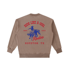 Back view of a Coffee Brown Vintage Washed Crewneck with a red and navy Houston TX Rodeo "Ride Like A Girl" graphic.
