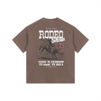 Back view of a Coffee Brown Heavyweight Boxy T-Shirt featuring a vintage white "Wild West Rodeo Show" bull riding graphic.