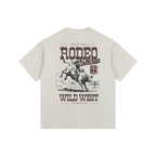 Back view of a Cream Heavyweight Boxy T-Shirt featuring a vintage espresso brown "Wild West Rodeo Show" graphic.