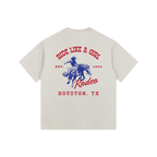 Back view of an Off-White Heavyweight Boxy T-Shirt with a red and blue Houston TX Rodeo "Ride Like A Girl" graphic.